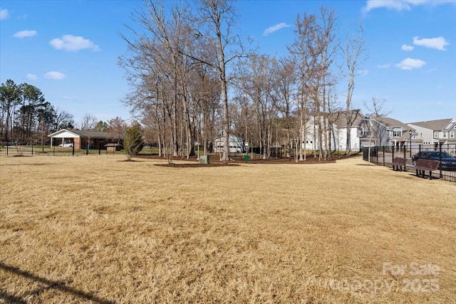 view of yard featuring a residential view and fence