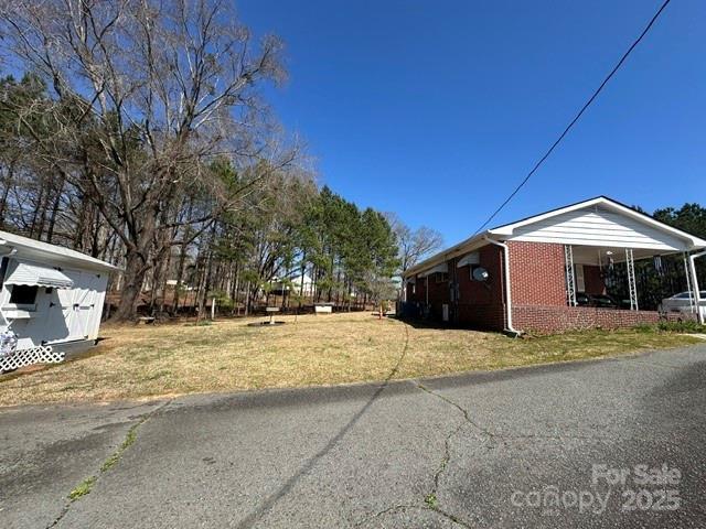 view of property exterior with a yard and brick siding