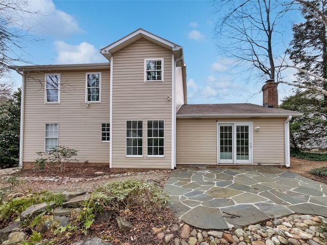 rear view of house featuring a chimney and a patio area