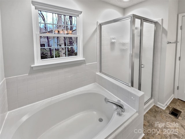 full bath with a shower stall, a garden tub, and visible vents