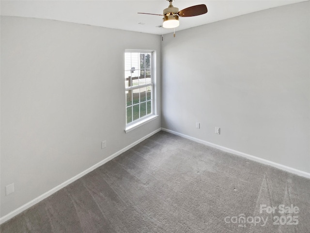 carpeted empty room featuring baseboards and ceiling fan