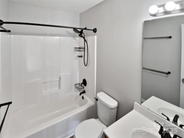 bathroom featuring vanity, toilet, and  shower combination