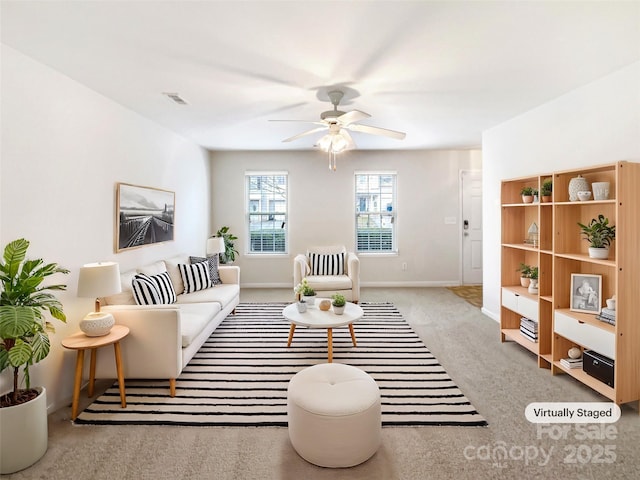 carpeted living room featuring a ceiling fan, visible vents, and baseboards