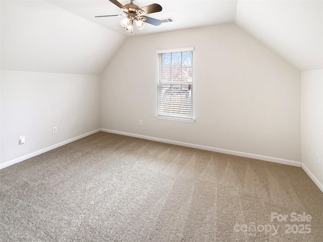 additional living space featuring visible vents, carpet flooring, and vaulted ceiling