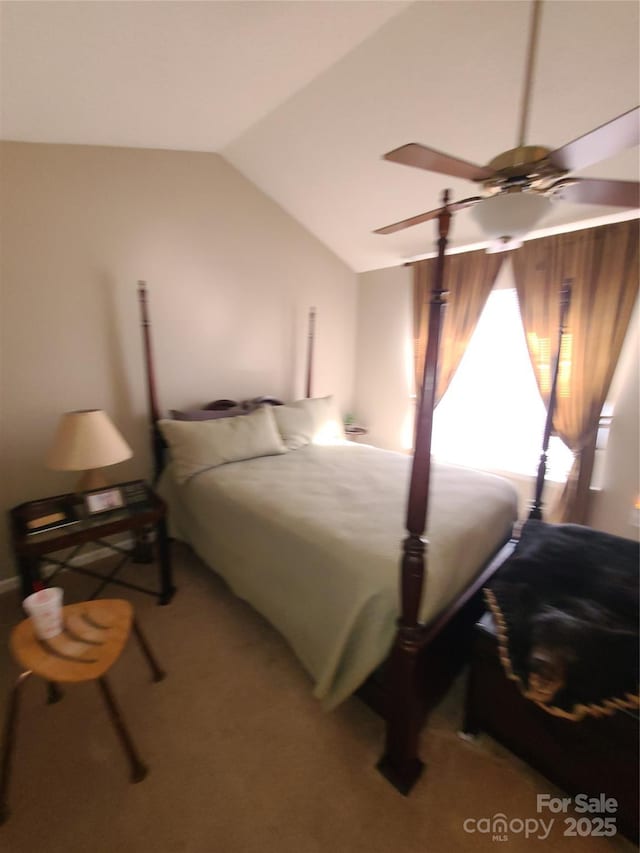 carpeted bedroom featuring lofted ceiling and a ceiling fan