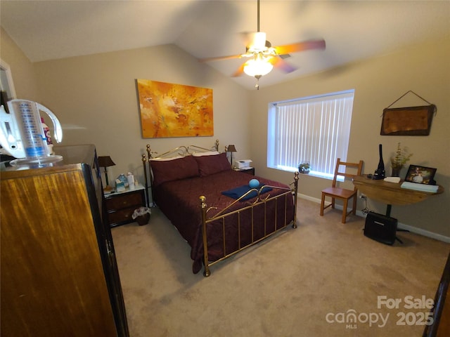 carpeted bedroom with lofted ceiling and baseboards