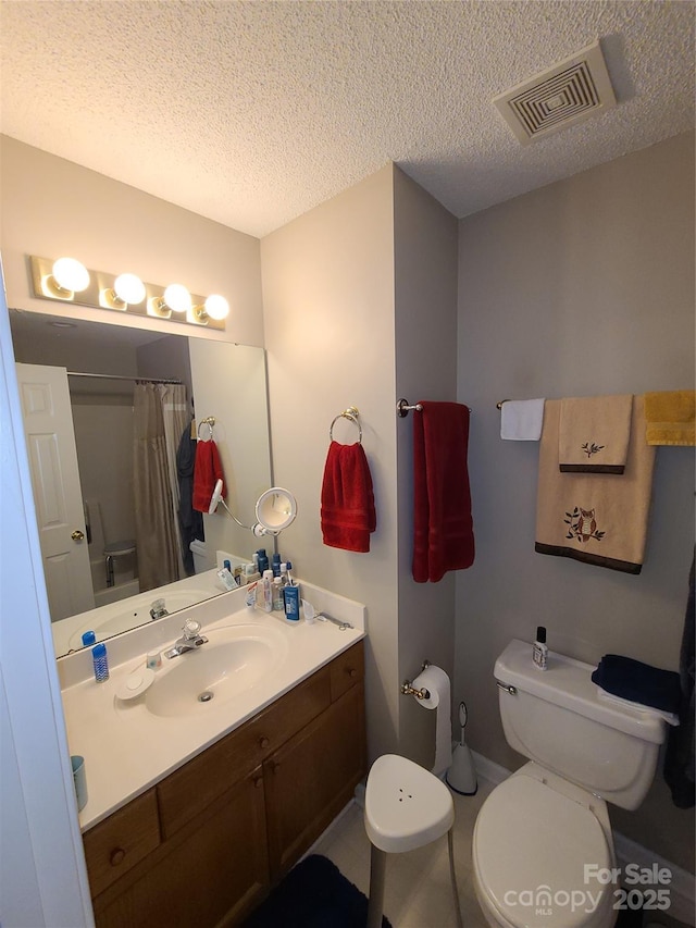 bathroom with visible vents, a shower with curtain, toilet, a textured ceiling, and vanity