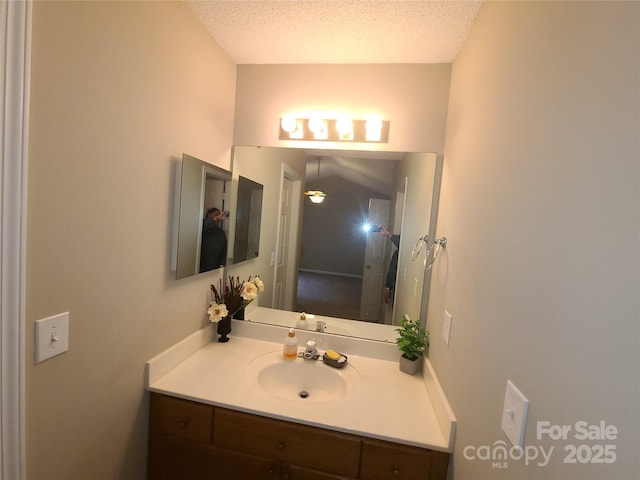 bathroom featuring vanity and a textured ceiling