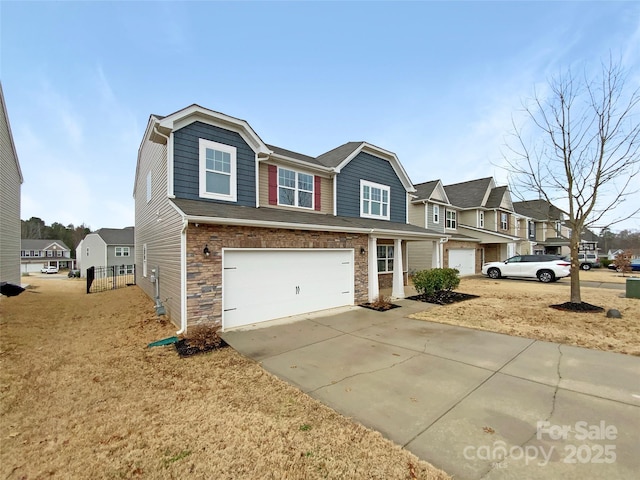 view of front of house featuring stone siding, driveway, an attached garage, and a residential view