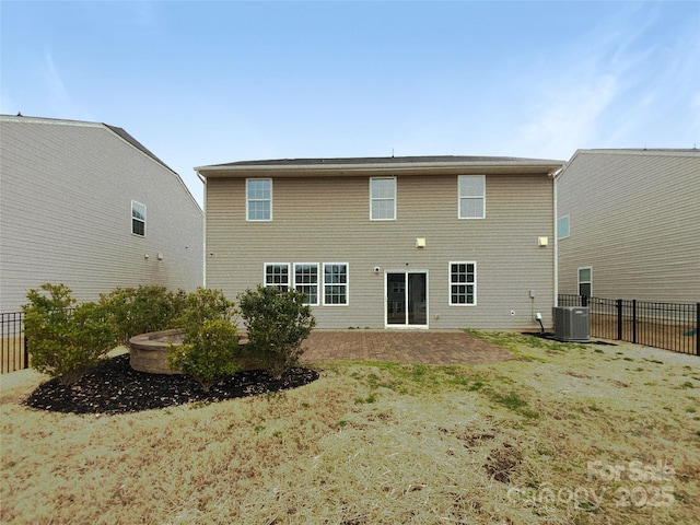 rear view of property with central air condition unit and fence