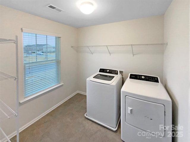 laundry room featuring visible vents, baseboards, washing machine and dryer, and laundry area