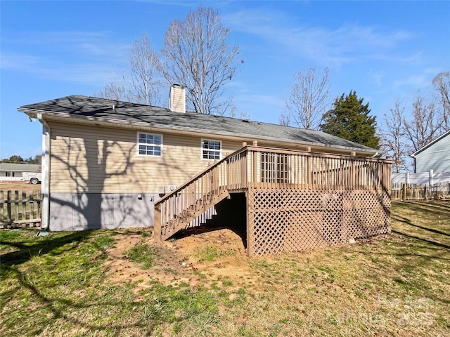 back of property featuring stairway, a chimney, a deck, and fence