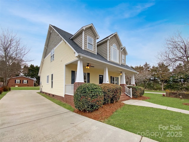 view of front of home featuring covered porch and a front lawn