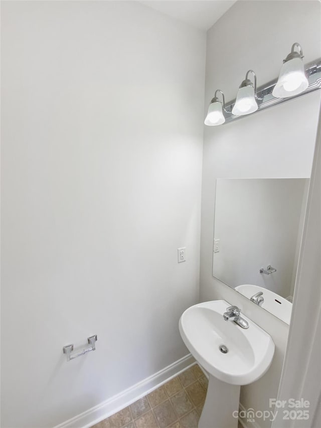 bathroom with baseboards and a sink