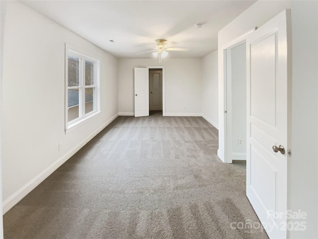 unfurnished bedroom with a ceiling fan, carpet, and baseboards