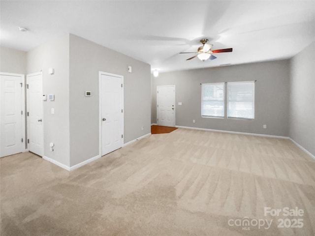 unfurnished room with carpet, baseboards, and ceiling fan