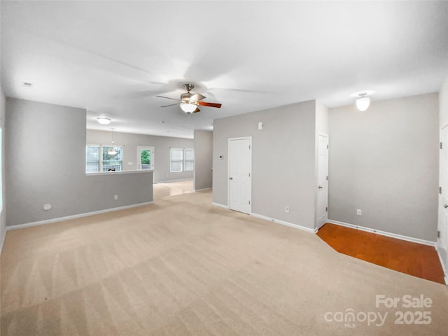 interior space with a ceiling fan and baseboards