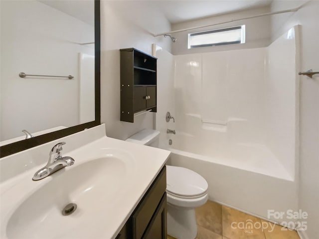 bathroom featuring vanity, tile patterned floors, toilet, and washtub / shower combination