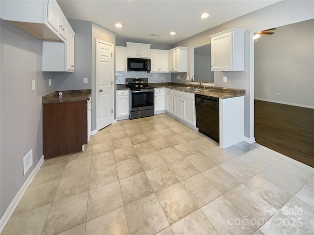 kitchen featuring ceiling fan, a sink, black appliances, white cabinetry, and dark countertops