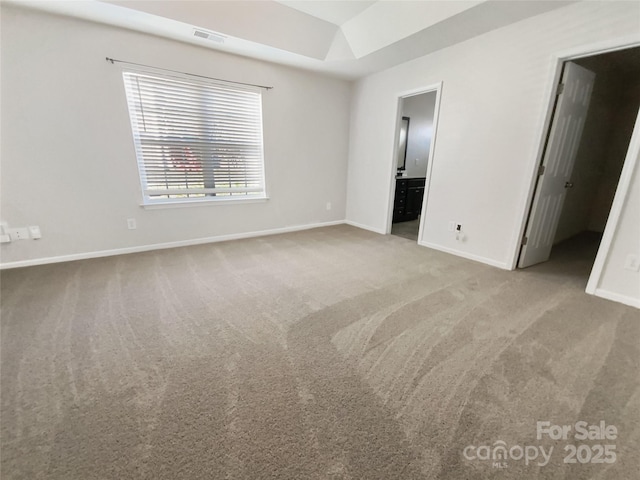 unfurnished bedroom featuring visible vents, baseboards, ensuite bathroom, and carpet flooring