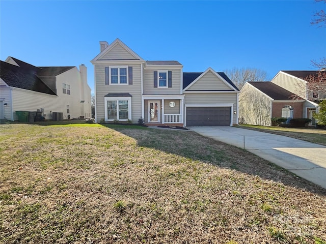 traditional home with a front yard, a garage, and driveway