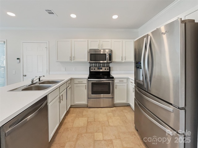 kitchen with visible vents, appliances with stainless steel finishes, light countertops, and a sink