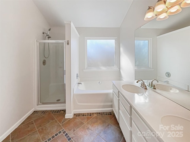 full bathroom featuring a shower stall, a garden tub, double vanity, and a sink