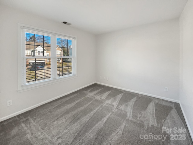 carpeted empty room with visible vents and baseboards