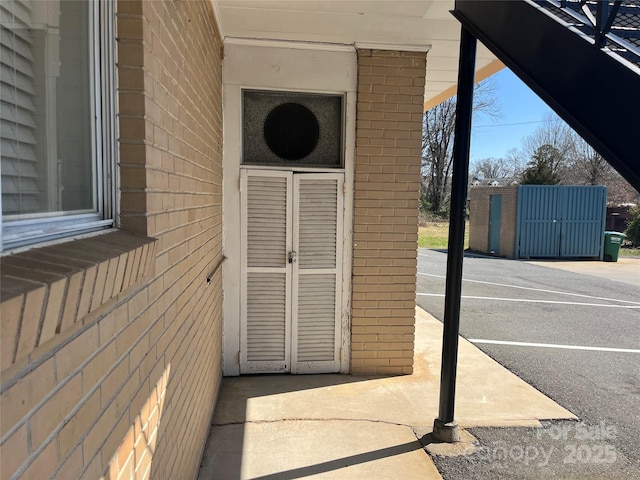 view of exterior entry featuring brick siding