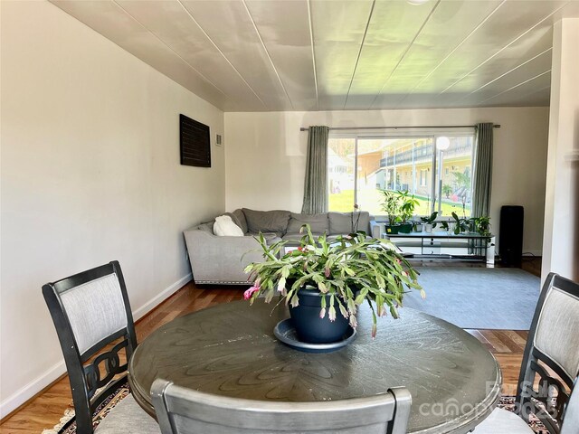 dining area featuring baseboards and wood finished floors