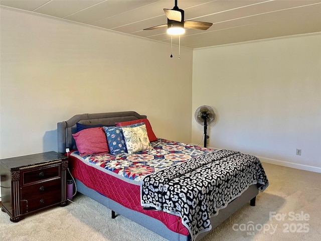 carpeted bedroom featuring a ceiling fan and baseboards