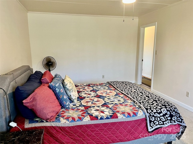 bedroom with baseboards and carpet floors