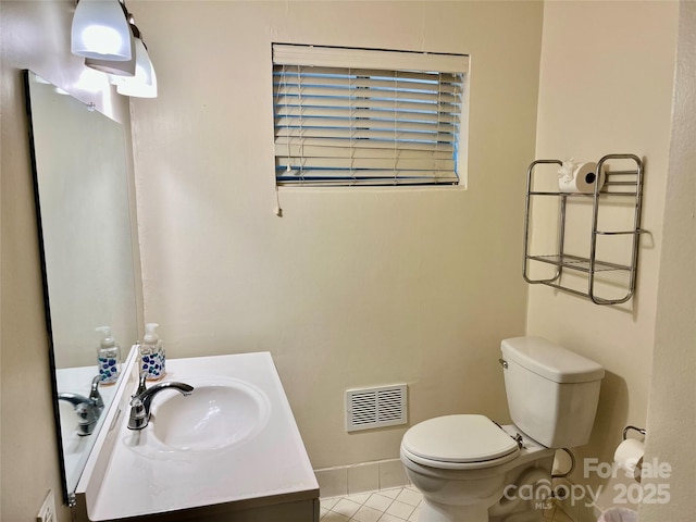 bathroom with vanity, toilet, visible vents, and tile patterned flooring