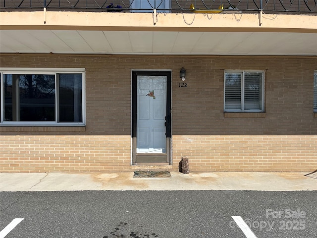 entrance to property with brick siding