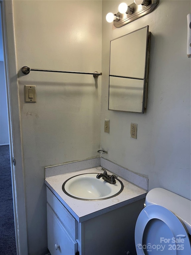 half bath featuring toilet and vanity