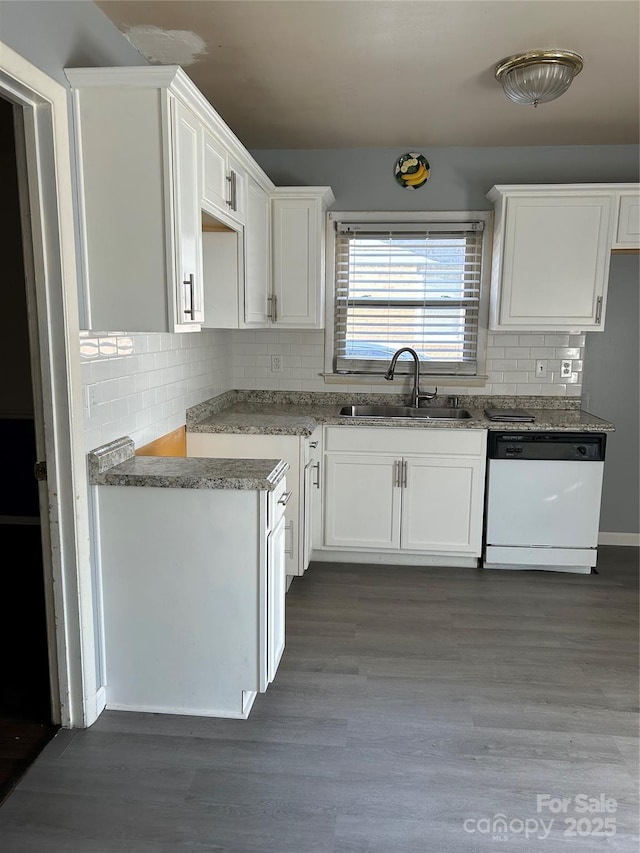 kitchen with dark wood-style floors, a sink, white cabinets, and white dishwasher