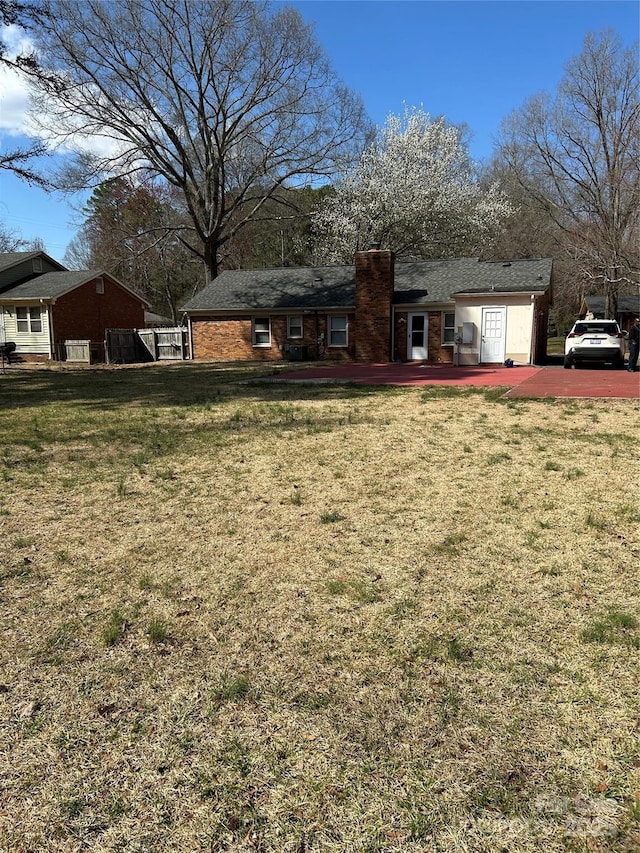 exterior space featuring a yard and a chimney