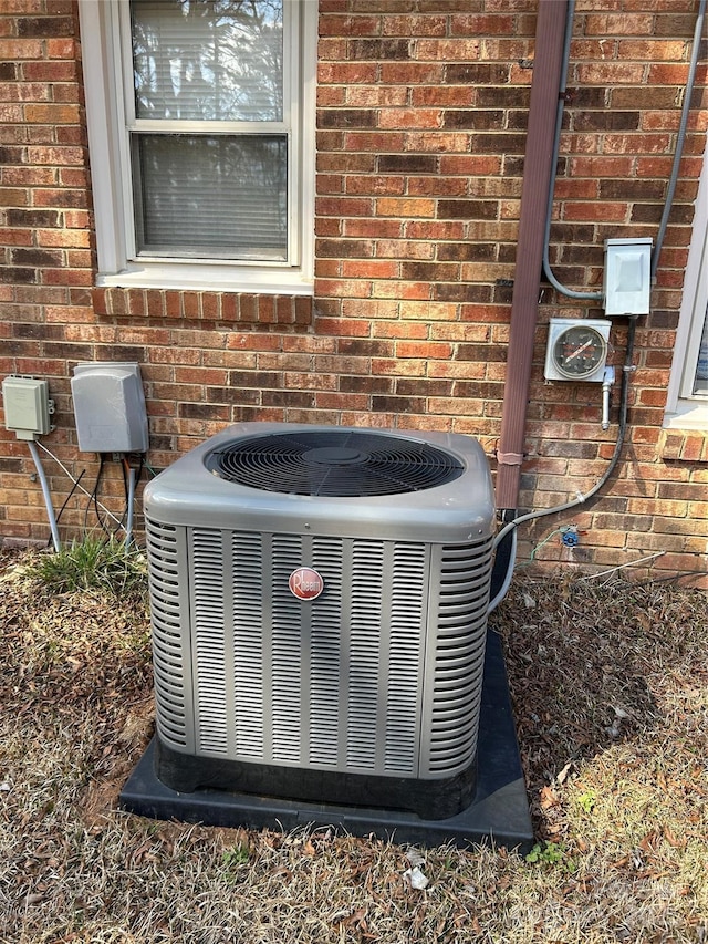 details with central air condition unit and brick siding