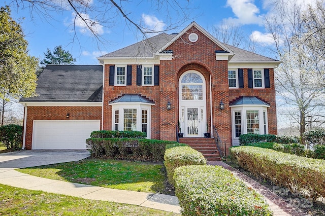 view of front of home featuring a garage, a front lawn, brick siding, and driveway