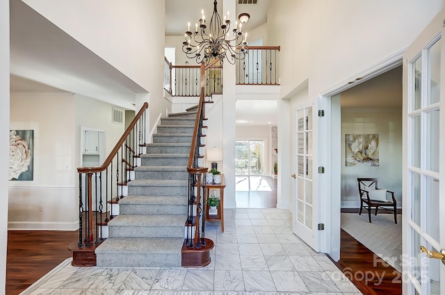 stairs featuring crown molding, french doors, marble finish floor, and baseboards