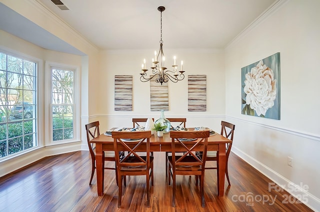 dining area featuring baseboards, dark wood-type flooring, an inviting chandelier, and ornamental molding