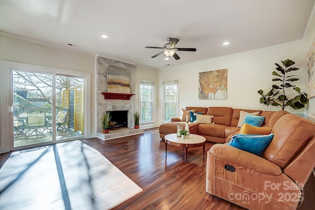 living room featuring recessed lighting, a fireplace, wood finished floors, and crown molding