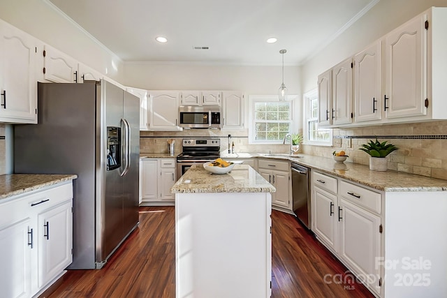 kitchen featuring a sink, appliances with stainless steel finishes, dark wood finished floors, and white cabinetry