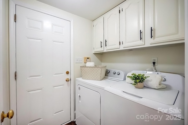 washroom featuring cabinet space and washing machine and dryer