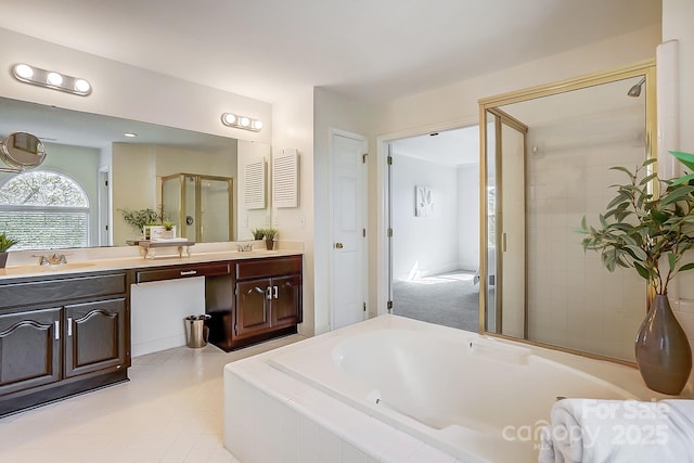 bathroom with vanity, a garden tub, and a shower stall