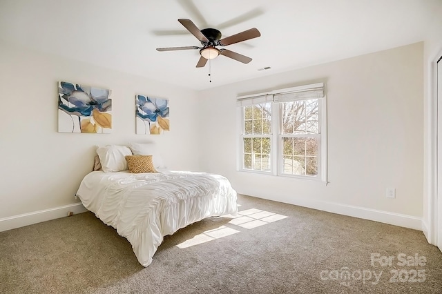 carpeted bedroom featuring visible vents, a ceiling fan, and baseboards