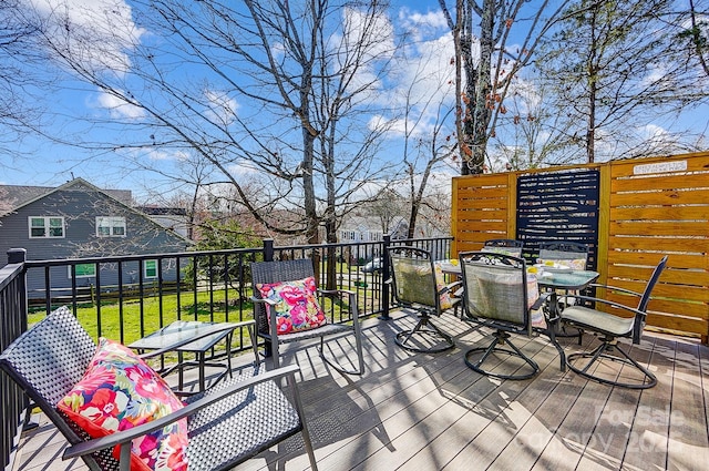 wooden terrace with outdoor dining space