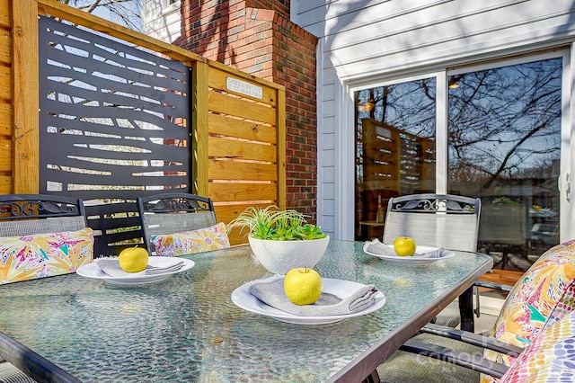 dining room featuring brick wall