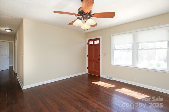 entryway featuring a ceiling fan, wood finished floors, visible vents, and baseboards