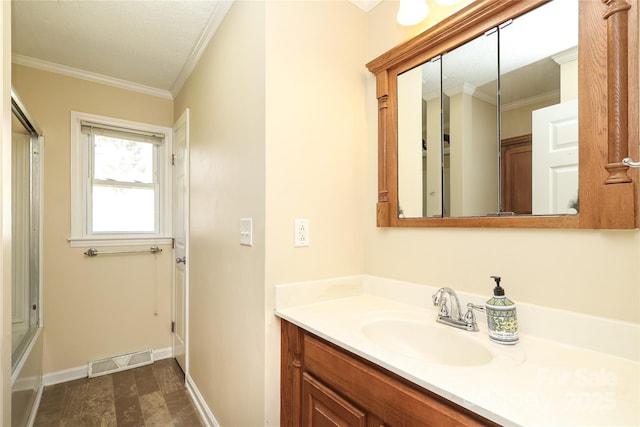 bathroom with vanity, baseboards, visible vents, and ornamental molding